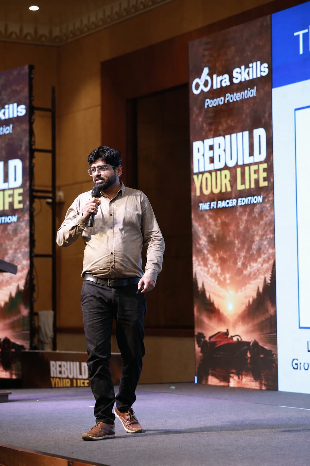 Hitesh Purohit speaking on stage at Ira Skills — Rebuild Your Life, The F1 Racer Edition